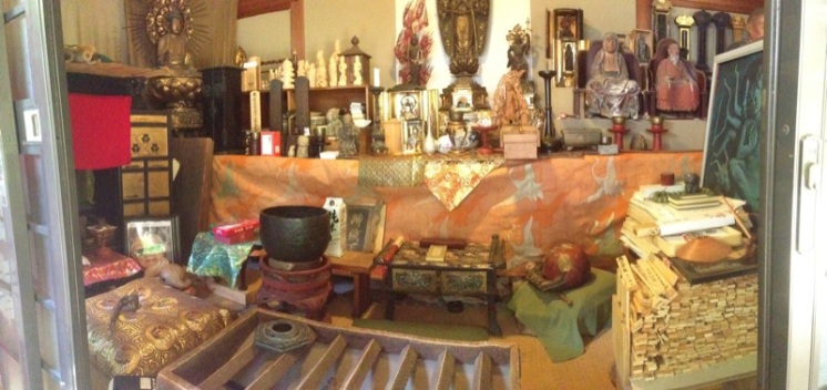Toward the back of the open yard was a small shrine. Inside lived a whole collection of sacred objects.